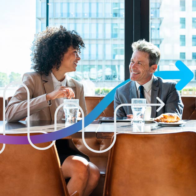 Two business people talking in a coffee shop.