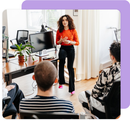 Woman presents to colleagues in the office.