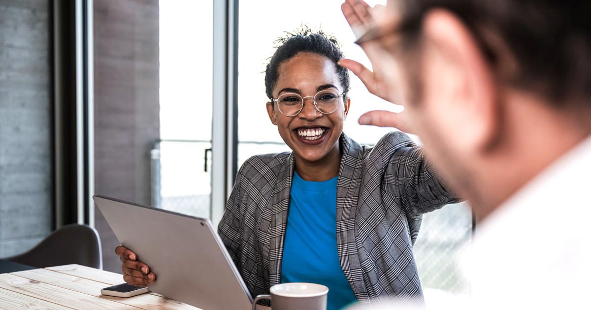 two nonprofit executives high-fiving after reaching their fundraising goal