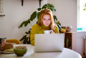 Woman on computer with DonorPerfect Support