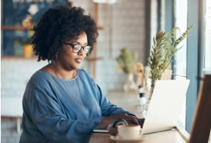 Woman on computer with DonorPerfect Support