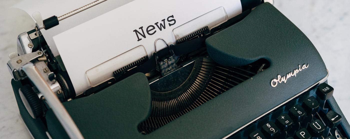 Newspaper being typed on typewriter
