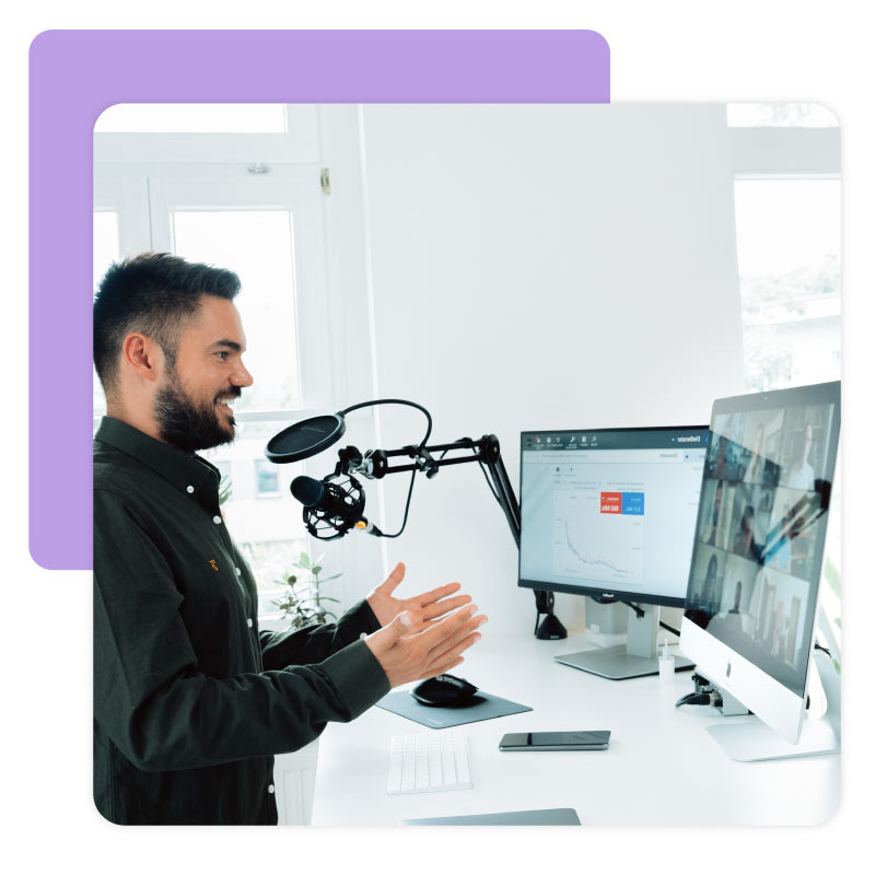 Person standing at desk hosting virtual webinar