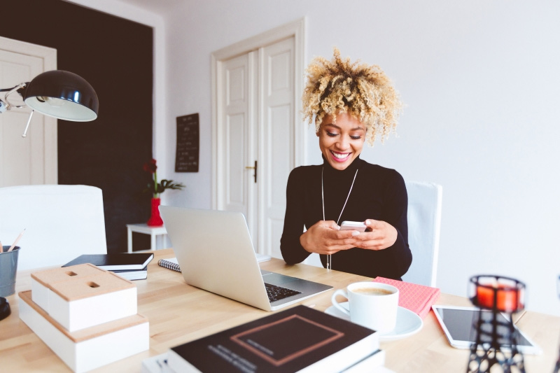 woman on phone with laptop