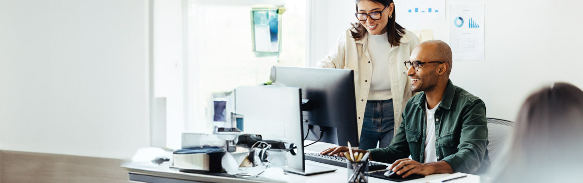 Two people working on a computer