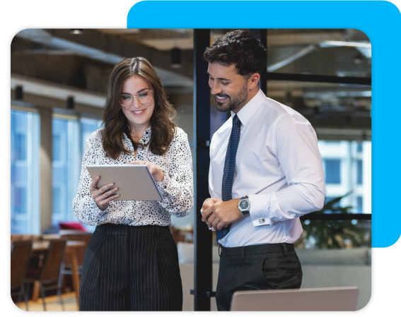 a man and a woman at work looking at a tablet to review data 